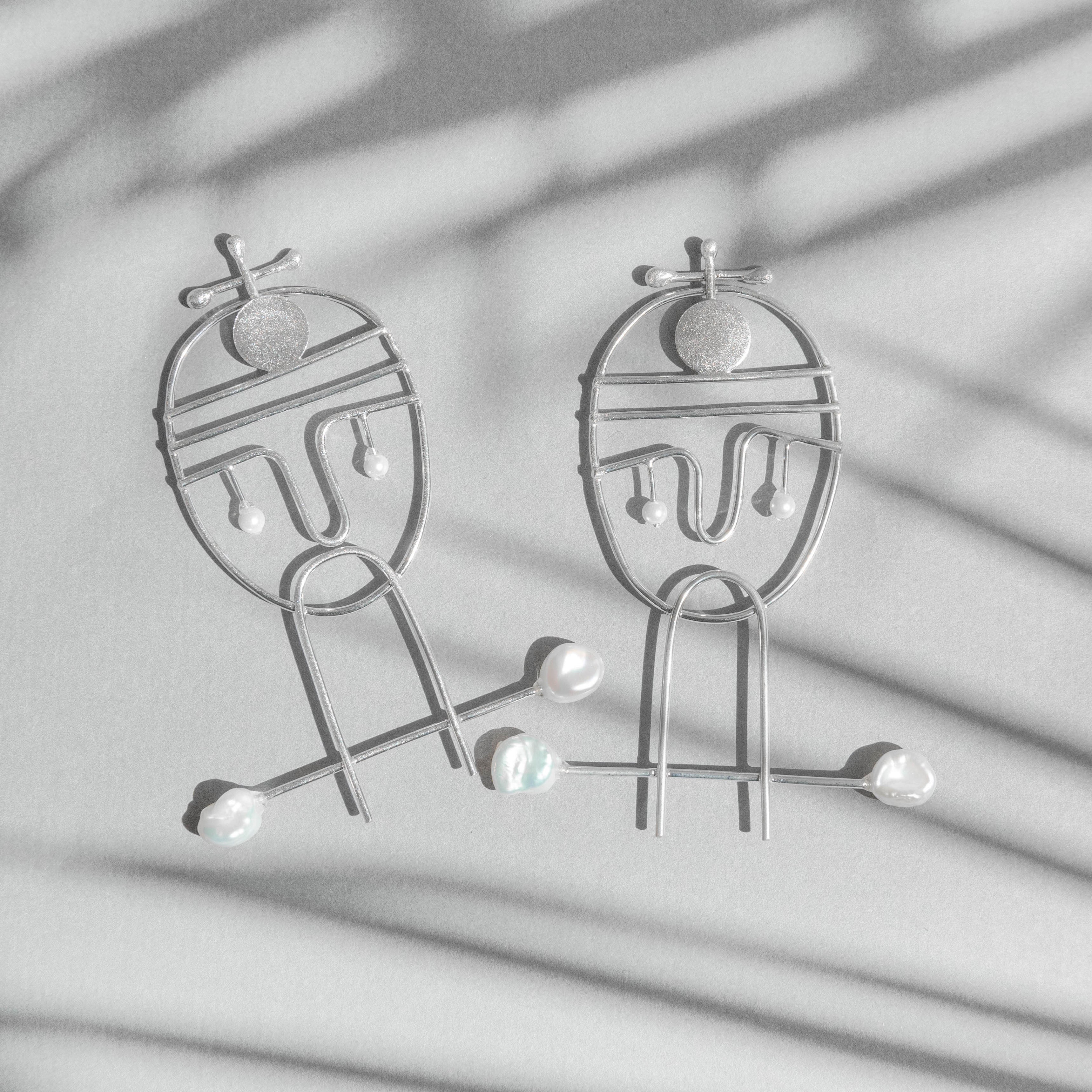 Portraiture, silver earrings